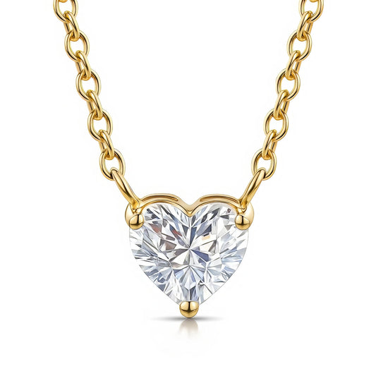 Gold necklace with a heart-shaped diamond pendant on a white background