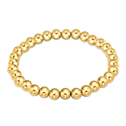 Gold beaded bracelet on a white background