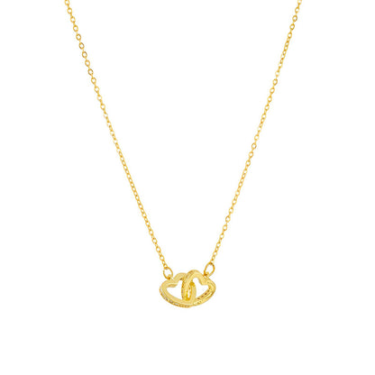 Gold necklace with a heart-shaped pendant on a white background