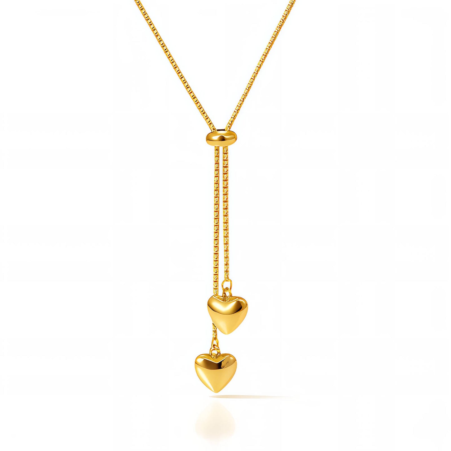 Gold necklace with heart-shaped pendants on a white background