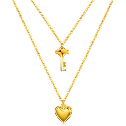 Two gold necklaces with a key pendant and a heart pendant on a white background