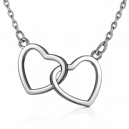 Silver necklace with interlocking heart pendants on a white background