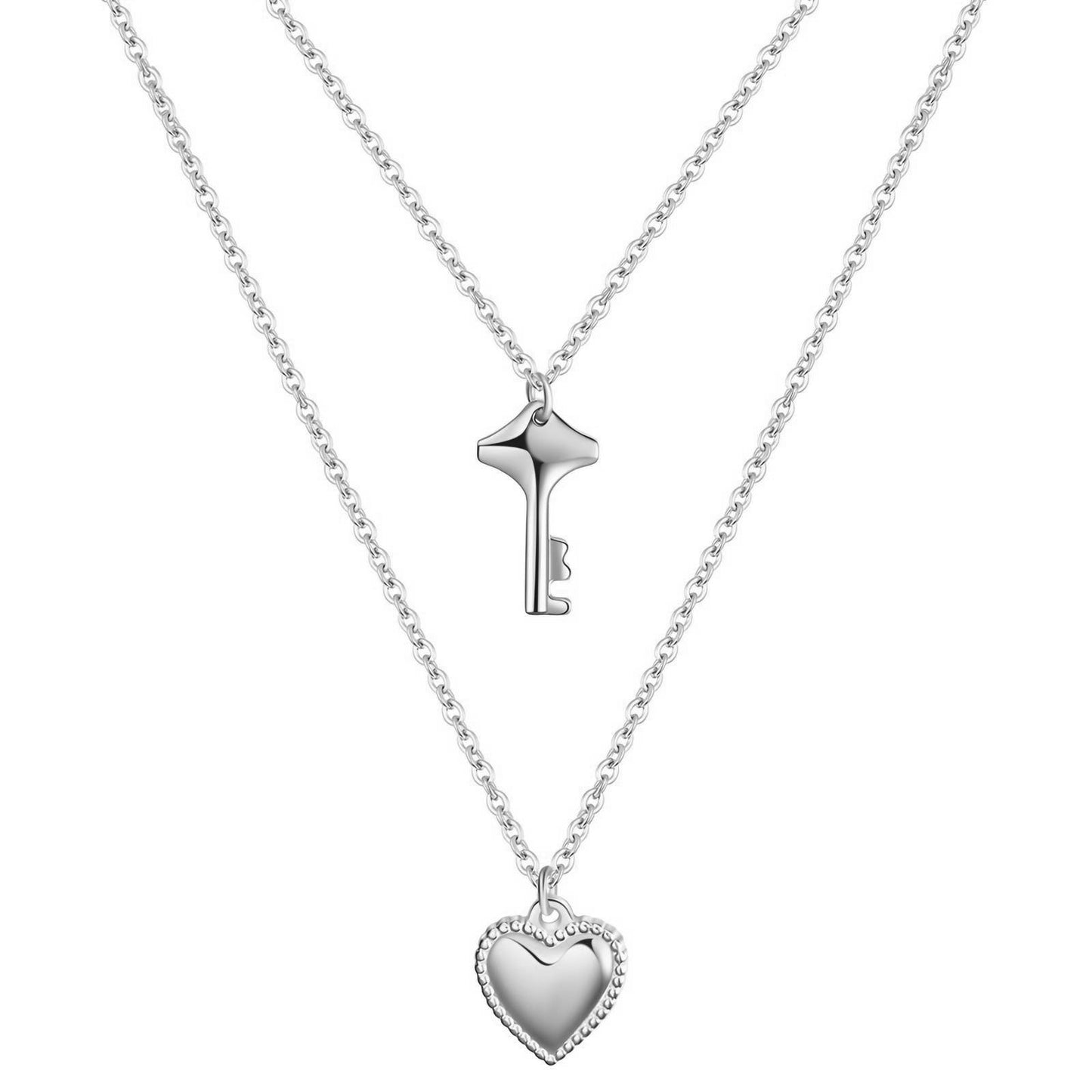 Silver key and heart-shaped pendant necklace on a white background