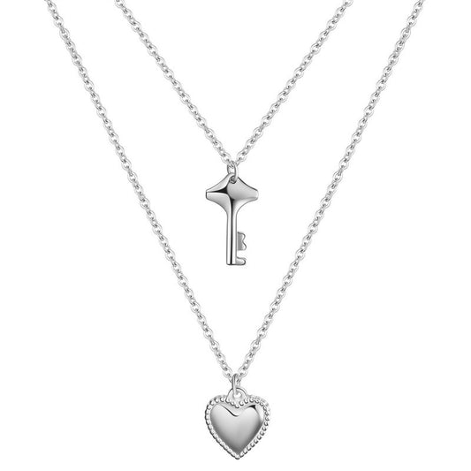Silver key and heart-shaped pendant necklace on a white background