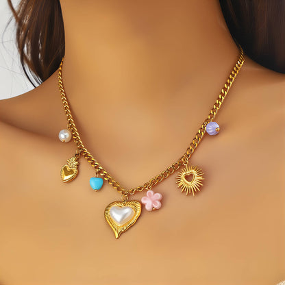 Gold necklace with heart and flower charms on a person's neck