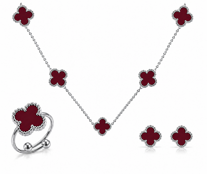 Jewelry set with red clover-shaped pendants on a white background